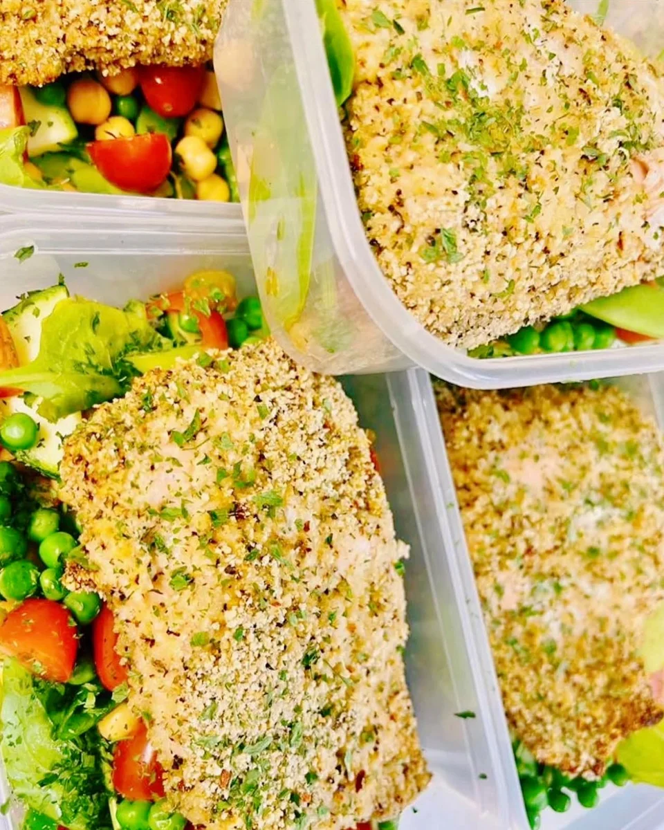 Crumb-coated fillets on peas with a tomato, chickpea and leaf salad