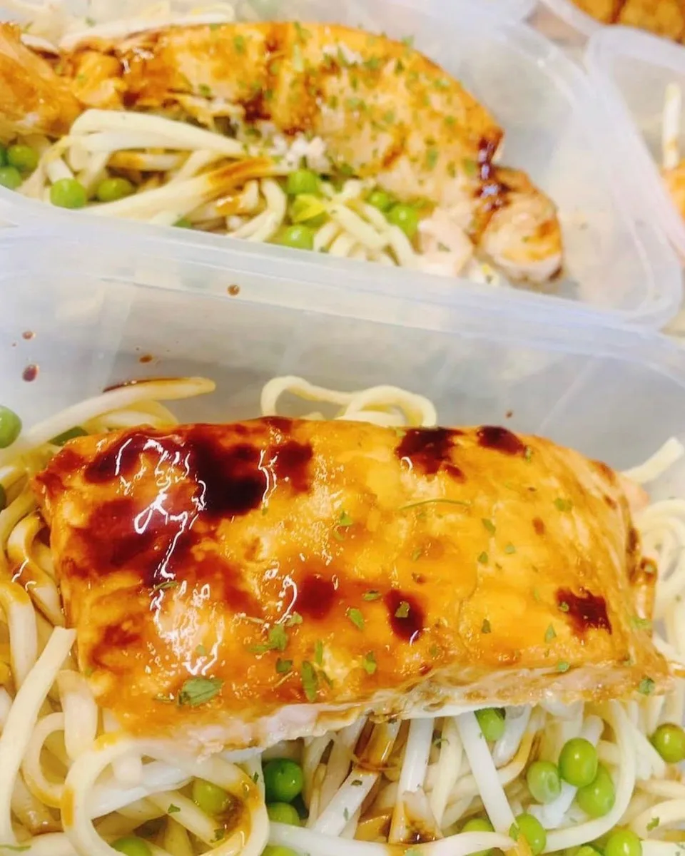 Glazed salmon on noodles with peas